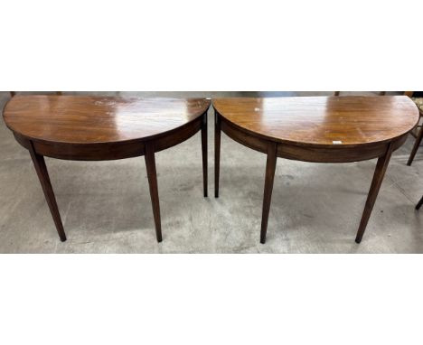 A pair of George III mahogany demi-lune console tables 