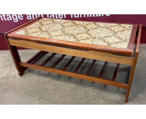 A teak and tile topped coffee table 