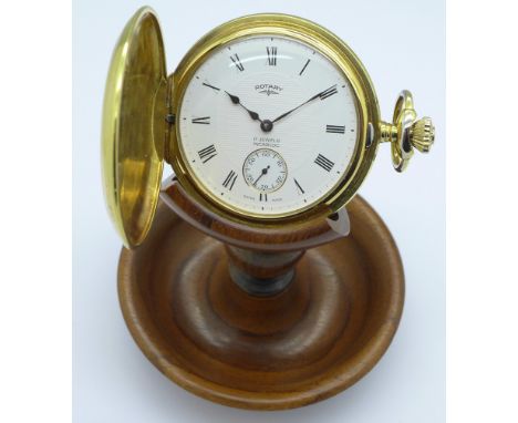 A Rotary plated full hunter pocket with 17 Jewels Incabloc manual wind movement and wooden pocket watch stand