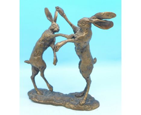 A bronze figure of two fighting hares after P. Jenk, 12cm