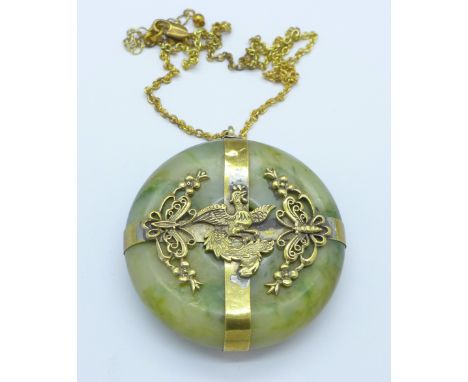 A heavy jade and gilt pendant, diameter 52mm