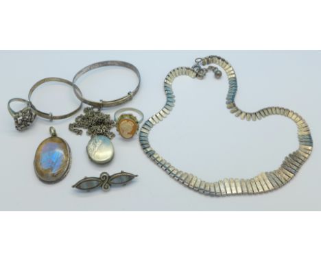 A silver necklet, two silver bangles, a silver marcasite ring, a sterling silver locket on a white metal chain, a silver agat