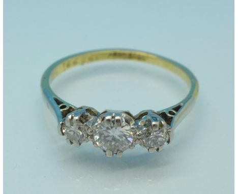 An 18ct gold, platinum and three stone diamond ring, total diamond weight 0.5 carats, 2.29g, O