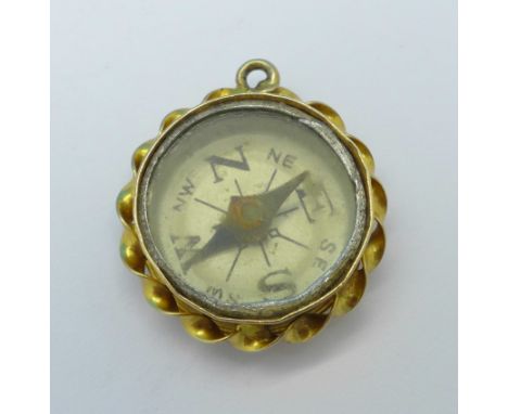 A hallmarked 9ct gold compass charm