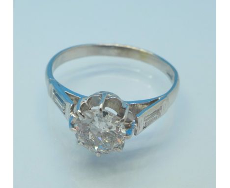 A platinum set Art Deco diamond solitaire ring with diamond baguette shoulders, c.1920's, principal diamond approximately 1 c