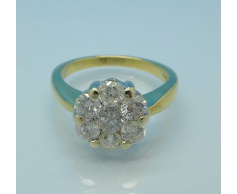 An 18ct gold, seven stone diamond cluster ring, 5.1g, L, colour J/K, clarity P1, total diamond weight 1.25 carats