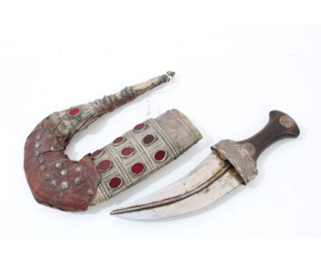 Old Arab jambia dagger with horn and white metal hilt, curved blade with central rib in ornate white metal and leather scabba