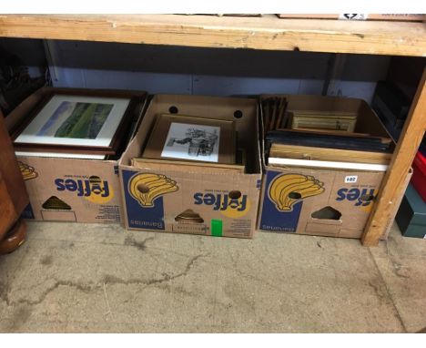 A shelf of framed pictures and prints