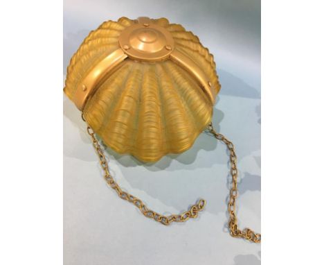 A scallop shell shaped hanging light shade