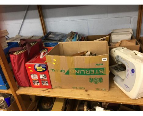 A shelf of assorted to include 'Janome' sewing machine, boxed camera monitoring system and LPs etc.