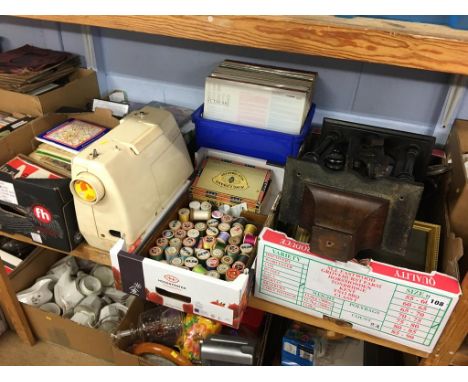 A shelf of assorted to include Singer 'Starlet' sewing machine, DVDs, LPs etc.