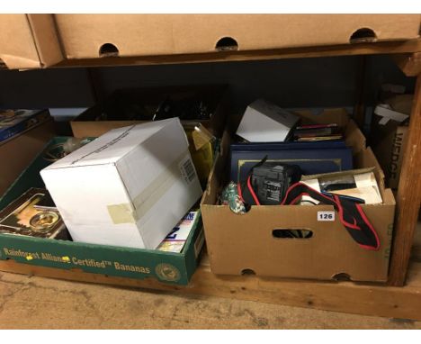 A shelf of assorted, CDs, magazines, binoculars etc.