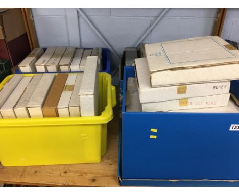 A shelf of boxed commemorative plates