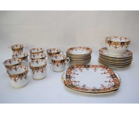 English porcelain tea set with a gilt and brown floral design comprising sandwich plate, side plates, sugar bowl, milk jug an