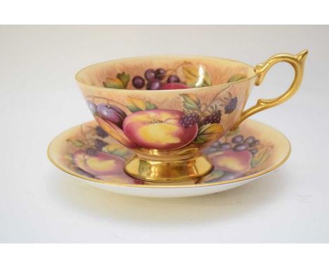 Aynsley cup and saucer decorated with fruit, the cup signed N Brunt