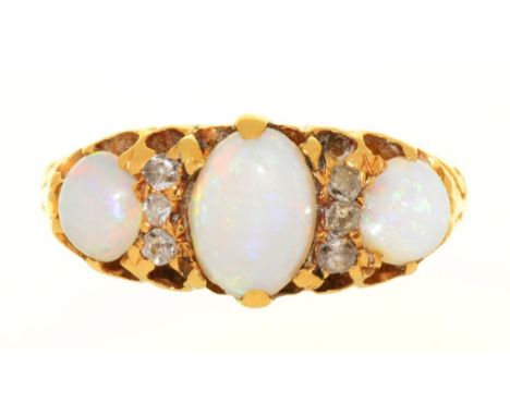 AN OPAL AND DIAMOND 3 STONE RING IN GOLD, UNMARKED.  THE CABOCHON OPALS APPROX 1CT, DIAMONDS APPROX 0.06 CT, 3G, SIZE K++WEAR