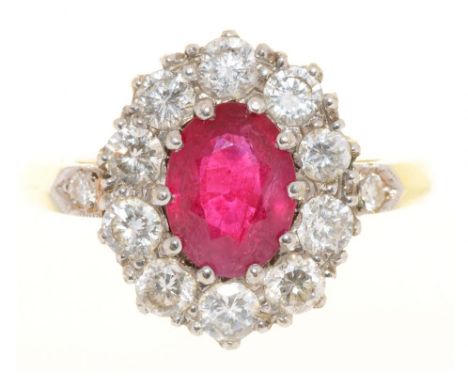 A RUBY AND DIAMOND RING IN GOLD MARKED 18CT, THE OVAL FACETED RUBY APPROX 1 CT, DIAMONDS APPROX 0.7 CT, 4G, SIZE N½++LIGHT SC