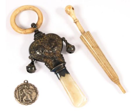 A GEORGE V  EMBOSSED AND HEART SHAPED BABY'S RATTLE, WITH MOTHER OF PEARL HANDLE, 9.5CM L, BIRMINGHAM 1915, A CARVED BONE PAR