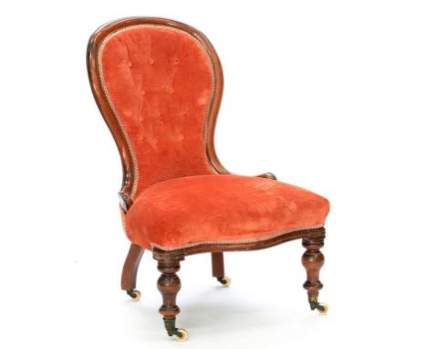 A VICTORIAN MAHOGANY NURSING CHAIR, UPHOLSTERED IN RED BUTTON BACK FABRIC 