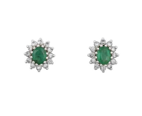 A Pair of 18 Carat Gold Emerald and Diamond Cluster Earrings the oval cut emeralds within borders of round brilliant cut diam