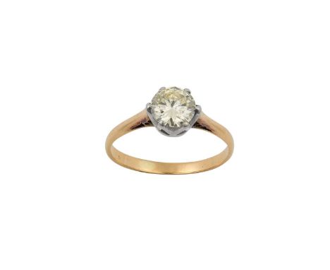 A Diamond Solitaire Ringthe round brilliant cut diamond in a white claw setting, to a yellow tapered shoulder plain polished 