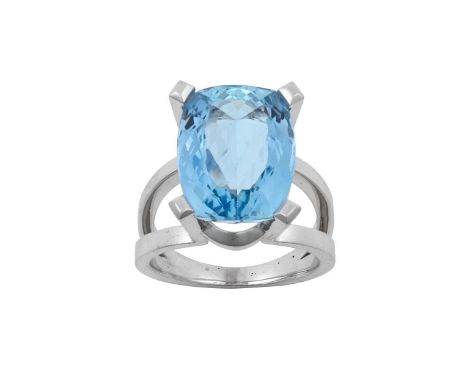 An Aquamarine and Diamond Ring the cushion cut aquamarine in a white four claw setting, the claws and underbezel set througho