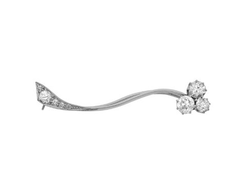 A Diamond Broochmodelled as a simplistic stylised floral spray, the white s-form plain polished bar terminating at one end wi