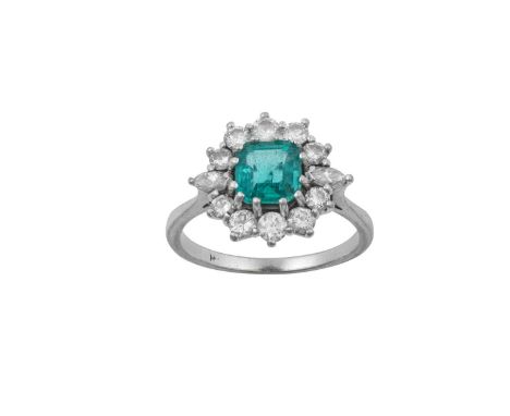 An Emerald and Diamond Cluster Ring the emerald-cut emerald within a border of round brilliant cut diamonds, with marquise cu