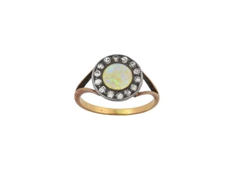 An Opal and Diamond Cluster Ringthe round cabochon opal within a border of old cut diamonds, in white claw and millegrain set
