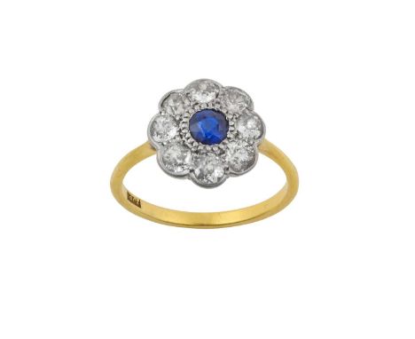 A Sapphire and Diamond Cluster Ringthe round cut sapphire within a border of old cut diamonds, in white claw and rubbed over 