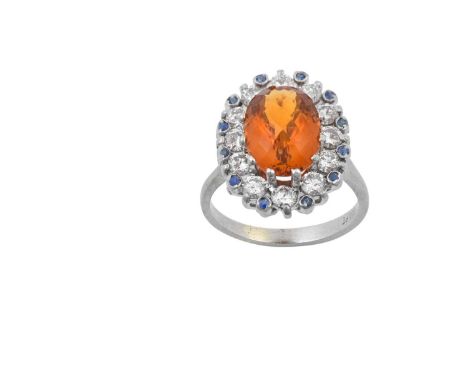 A Citrine, Sapphire and Diamond Cluster Ringthe oval faceted cabochon citrine within a border of round brilliant cut diamonds