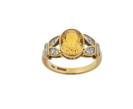 An 18 Carat Gold Yellow Beryl and Diamond Ringthe oval cut yellow beryl in a yellow rubbed over setting, to leaf motif should