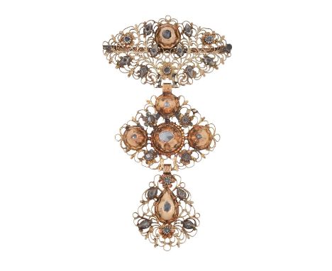 A Diamond Brooch/Pendant three yellow articulated filigree panels decorated throughout with lasque cut diamonds, in yellow an