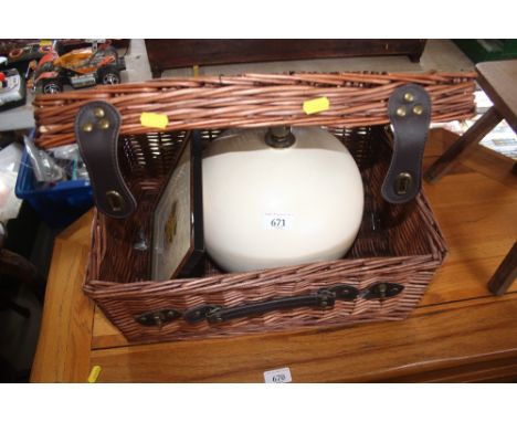 A wicker picnic basket and contents of a table lamp and framed embroidery