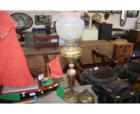 A brass oil lamp with floral graft shade and chimney 