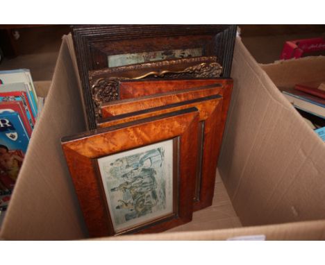 A box containing various framed prints