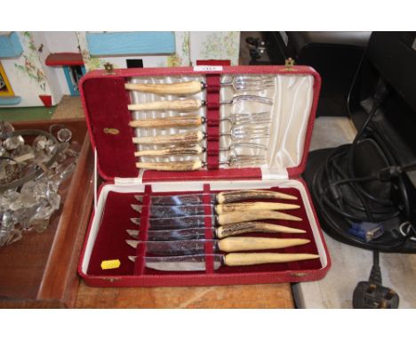 A horn handled knife and fork set 