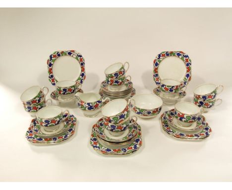 A 1930s Bridgwood Anchor China tea service with unusual abstract decoration in red, green and blue,  comprising twelve cups, 