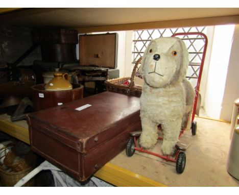 A leather suitcase containing a quantity of horse bridles, 19th century brass trivet, vintage Singer sewing machine, bread cr