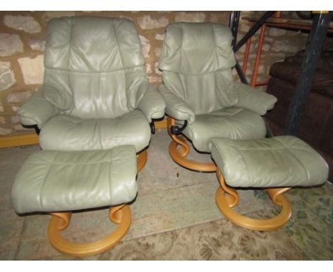 Pair of Ekornes Stressless reclining chairs with footstools, classic light green leather finish, natural wood framework Vegas