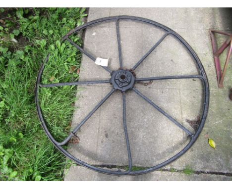 A vintage cast iron eight spoke implement wheel, 132 cm diameter approx.