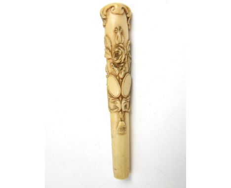 A Victorian carved bone parasol or walking stick handle with floral detail