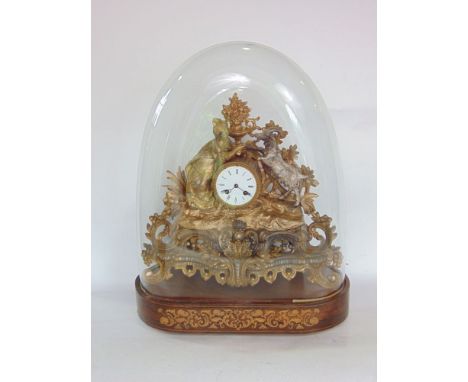 French two train gilt metal figural mantel clock, decorated with a lady and goat amidst foliage, under an oval glass dome and