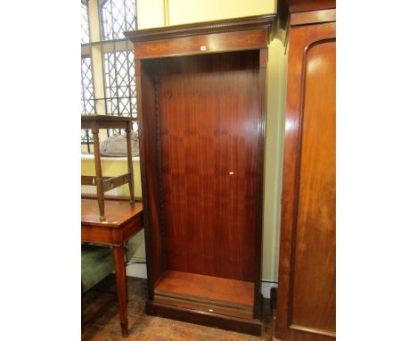 A good quality Edwardian style mahogany bookcase of full height with carved dentil frieze below an inlaid floral swag and gar