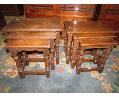 A nest of three graduated occasional tables in oak in an old English style with turned bobbin support and a further similar s