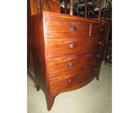 A Georgian mahogany bow fronted chest of three long and two short drawers with caddy top raided on swept support. 105cm wide