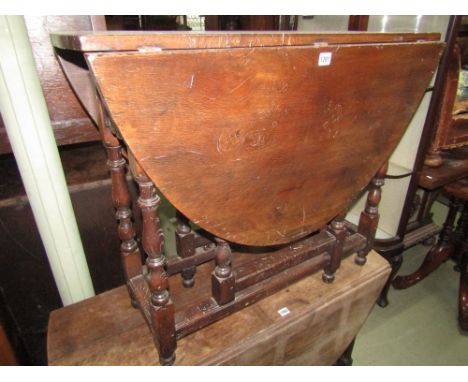 A good quality old English style gate leg table with figured top raised on eight baluster supports with  carved detail.