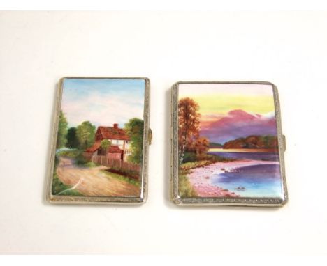 A pair of white metal cigarette cases with applied enamel fronts of landscapes scenes (2)