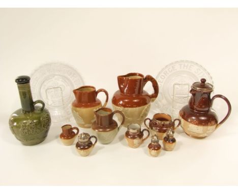 A collection of Doulton and other salt glazed stone wares including a jug with offset handle and silver mount, with toper and