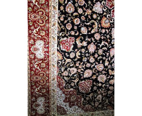 A good quality modern Persian carpet profusely decorated with scrolled foliage upon a black ground, 310 x 200 cm approx